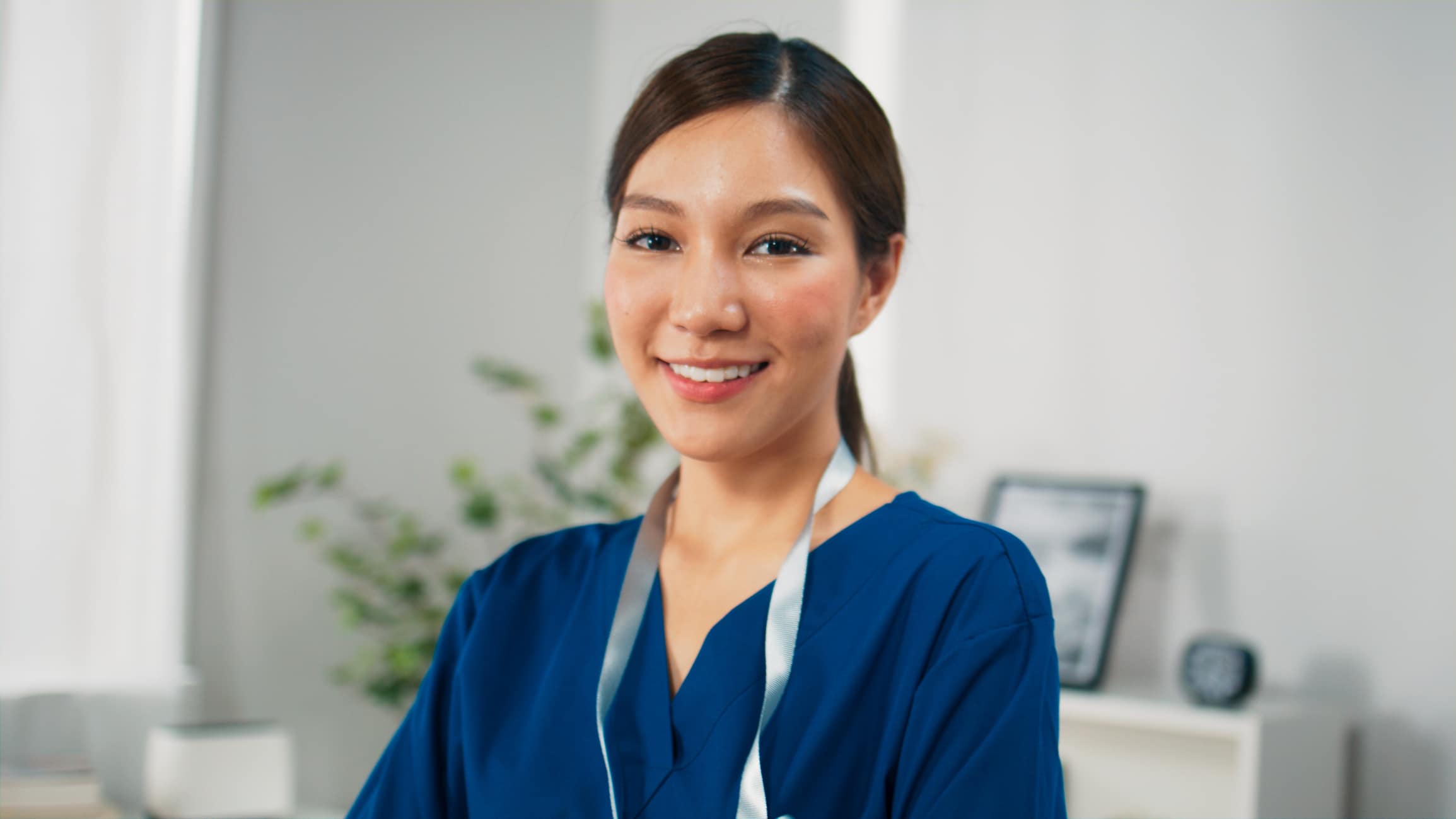 Portrait of young Asian healthcare doctors or nurse in scrubs looking at camera and posing with confident smile, Medical technicians with activities in daily life, Lifestyle in scrubs